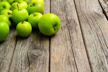 green apples on old wooden background