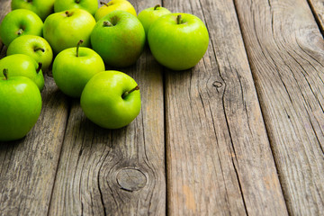 green apples on old wooden background