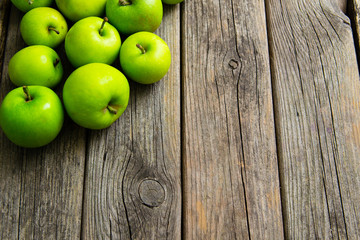 green apples on old wooden background