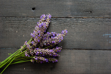 purple lavender flowers on black wooden table background