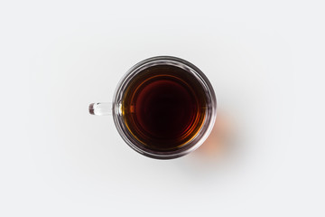 Top view of glass cup of hot tea on white background