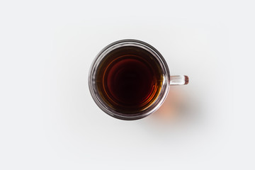 Top view of glass cup of hot tea on white background