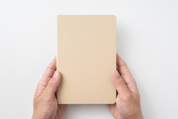 man hand hold hardcover kraft notebook