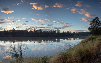 Fototapeta premium River sunrise with reflections and colourful sky