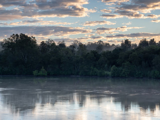 Obraz na płótnie Canvas River sunrise with reflections and colourful sky