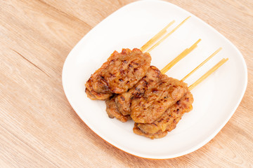 Thai street food, Moo ping (Thai word) grilled pork on white plate
