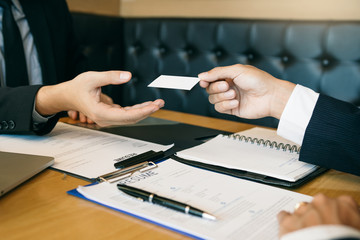 Employees submit business cards to job interviewers and interested in joining him contact immediately.