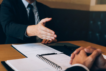 Confident partnerships people shaking hands with making a contract in the office.