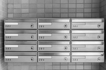 Metal letter box with room number at apartment building