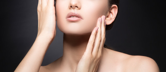 Lips, hands, shoulder, part of face  of young beauty woman isolated on black background