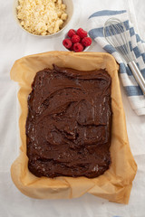 Closeup of chocolate cake with raspberry and streusel on a table