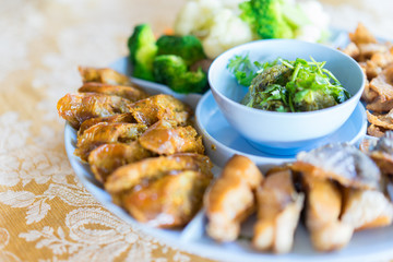 Northern Thai food: Northern Thai Green Chilli Dip (Nam Prik Num) served with Sai Aua (herb and spice sausage) and boiled vegetables.