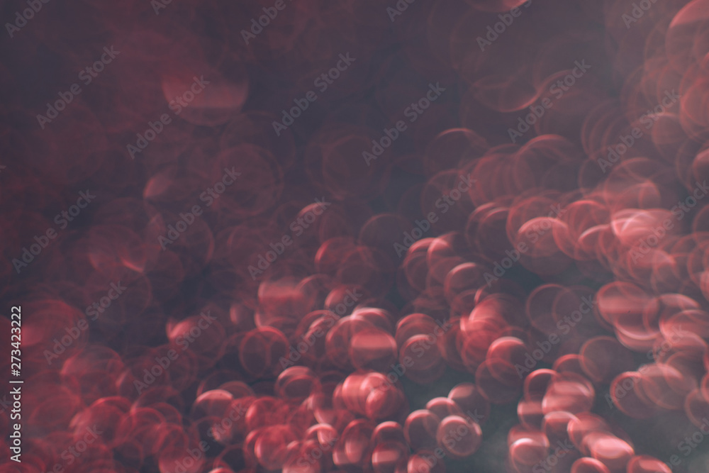 Poster beautiful red bokeh on a dark abstract background.