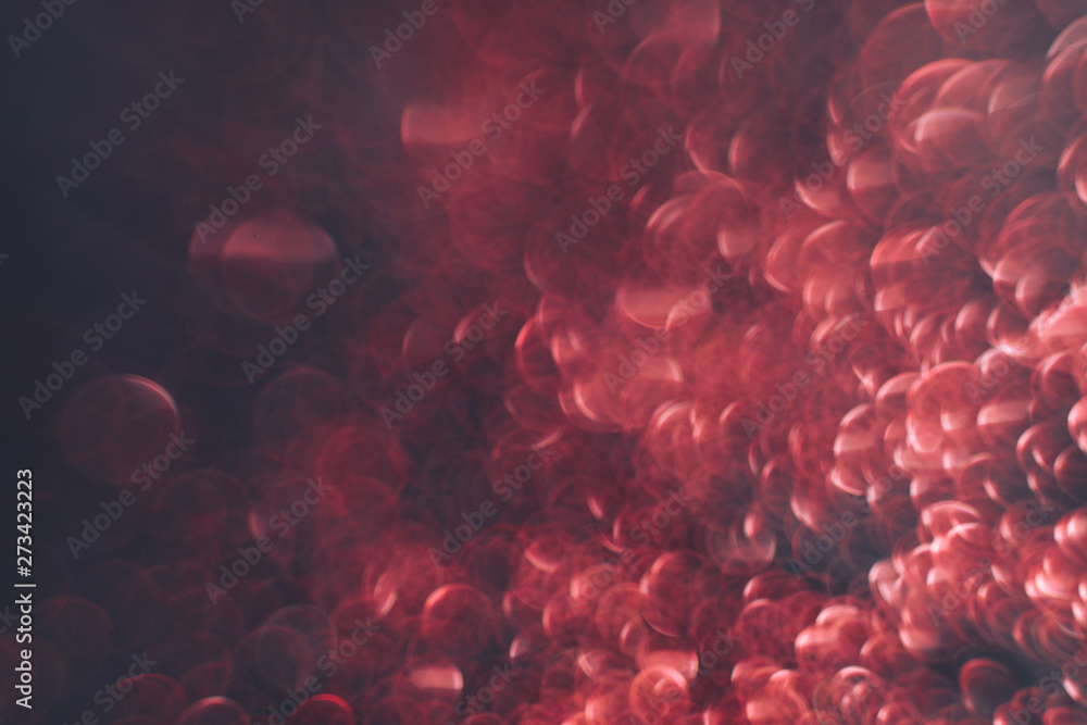 Poster Beautiful red bokeh on a dark abstract background.