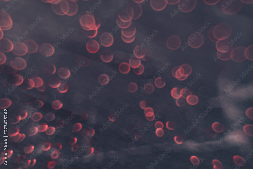 Poster beautiful red bokeh on a dark abstract background.