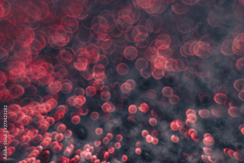Poster beautiful red bokeh on a dark abstract background.