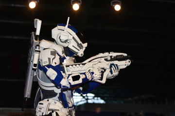 Android fighting robot moves with weapon indoors