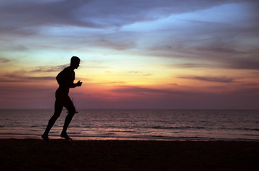 Fototapeta na wymiar Young, fit man doing jogging on a tropical beach