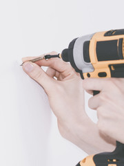 Person drilling in wall