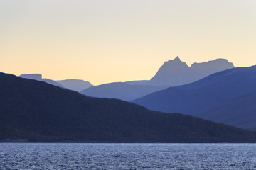 Fototapeta na wymiar Norwegian fjords with rocky horizon at sunrise