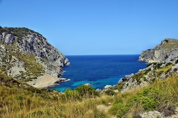Fototapeta premium Sea bay with turquoise water, beach and mountains, Cala Figuera on Cap Formentor