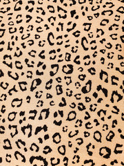 Beige leopard skin free style print background on clothing fabric