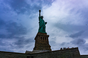 November 2018 - Statue of Liberty on light blue sky, landmark in New York City, USA, bottom view.