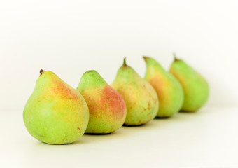 Fresh ripe pears on white background, vegetarian concept.