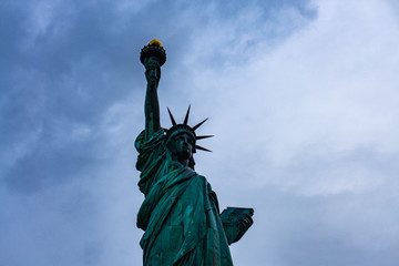 Fototapeta premium November 2018 - Statue of Liberty on light blue sky, landmark in New York City, USA, bottom view.