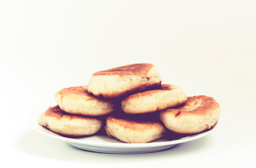 Fototapeta na wymiar Traditional homemade fried patties or pies made of yeast dough in a rustic style on white plate.