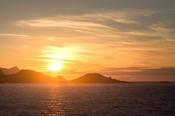 Naklejka na ściany i meble Norwegian fjords with rocky horizon at sunrise