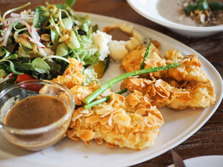 Crispy fish stick with almond sliced served with fresh salad and creamy mayonnaise dressing. Healthy food concept.