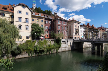 Fototapeta na wymiar Ljubljanica River as it passes through the Coblers Bridge in the city of Ljubljana, Slovenia