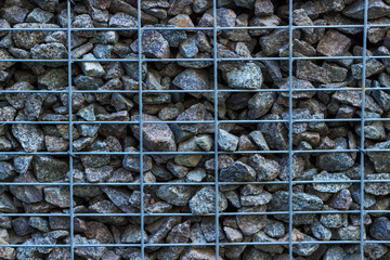 wall of stones in a metal grid