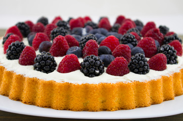 Dessert with fruits and mascarpone, fresh fruits, raspberries, blackberries and blueberries. Summer or spring light dessert in Italian style.