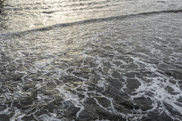 Beautiful golden texture of sea water. Horizontal color photography.