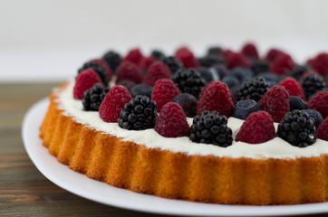 Dessert with fruits and mascarpone, fresh fruits, raspberries, blackberries and blueberries. Summer or spring light dessert in Italian style.