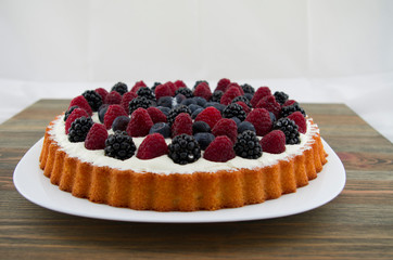 Dessert with fruits and mascarpone, fresh fruits, raspberries, blackberries and blueberries. Summer or spring light dessert in Italian style.