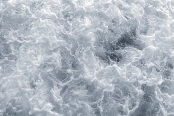 Beautiful stormy dark sea water with white fluffy foam on surface. Beautiful natural background. Horizontal color photography.