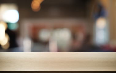 Empty dark wooden table in front of abstract blurred bokeh background of restaurant . can be used for display or montage your products.Mock up for space.