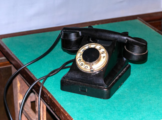 Old phone with a round set of numbers.