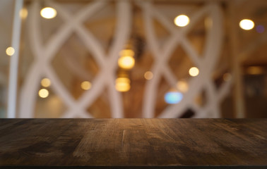Empty dark wooden table in front of abstract blurred bokeh background of restaurant . can be used for display or montage your products.Mock up for space.