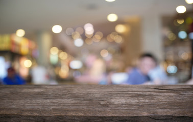 Empty wood table top and blur of night market background/selective focus .For montage product display.