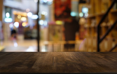 Empty wood table top and blur of night market background/selective focus .For montage product display.