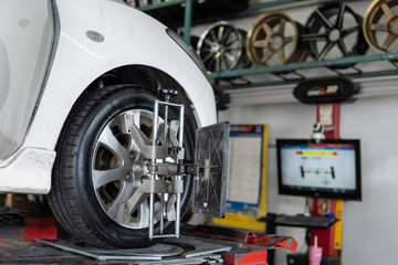 Car wheel centering machine adjustment selective focus on machine caliper ,Auto mechanic sets the...