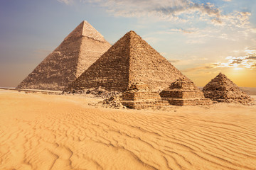 Fototapeta na wymiar Beautiful sunset view of the Pyramid of Menkaure with companions and the Pyramid of Chephren, Egypt