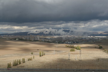 Obraz premium Air pollution created by the smoke coming from the chimney of the cement factory in Turkey's capital city Ankara, cities, mountains and clouds.