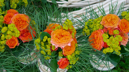 Bouquets of orange roses in retro jars 