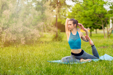 Young Caucasian woman doing yoga in the Park.