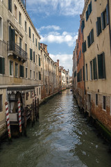 Fototapeta na wymiar Italy. Venice is one of the most unusual and beautiful cities in the world. Narrow channels - the streets often do not even have sidewalks. Movement only by water transport - gondolas or boats.